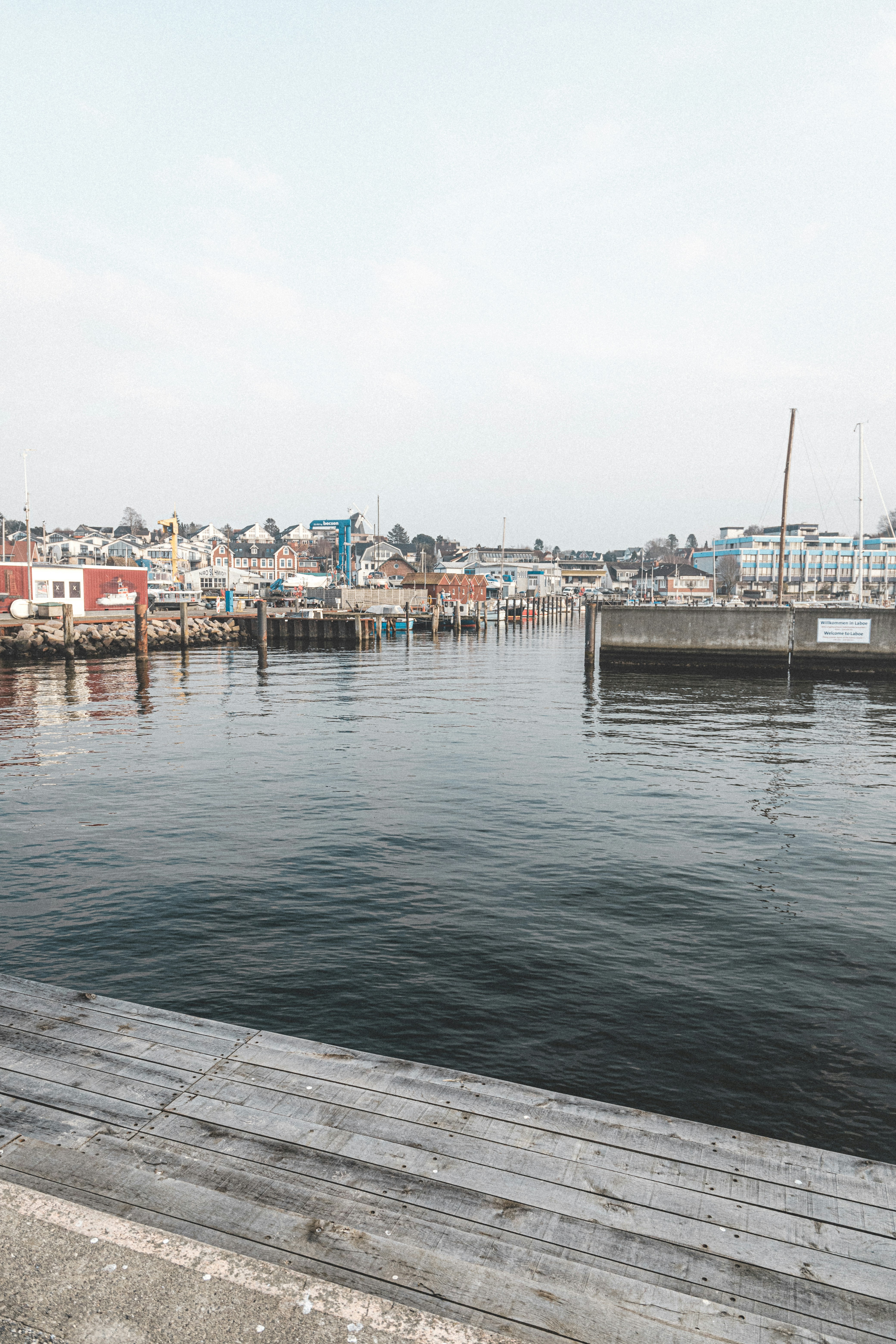 a man sitting on a bench next to a body of water