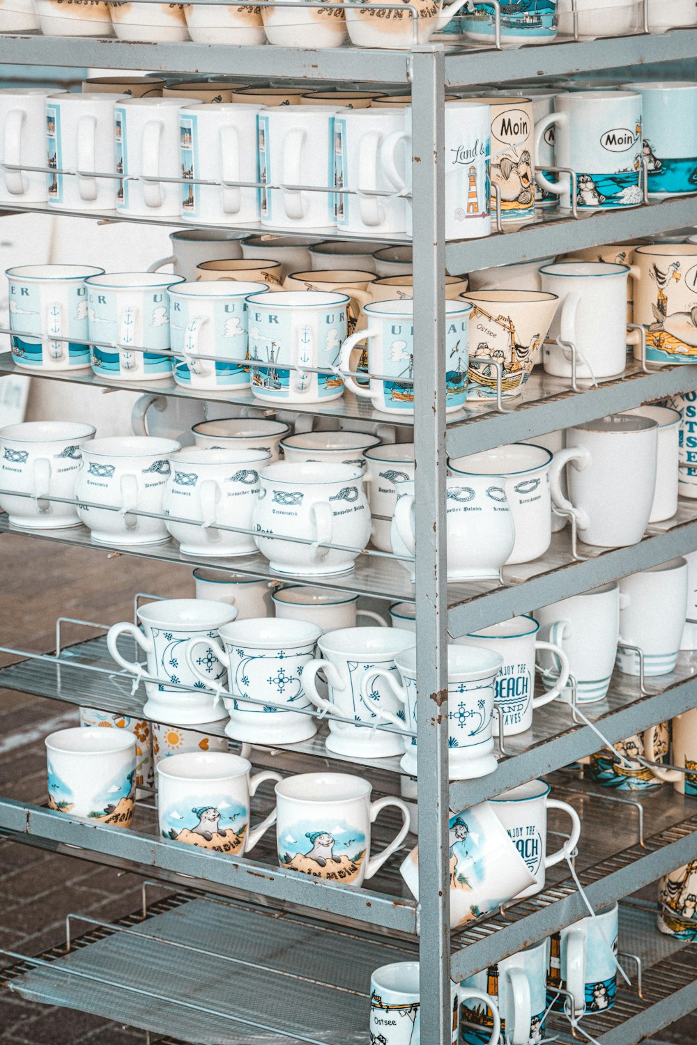 a rack filled with lots of cups and mugs