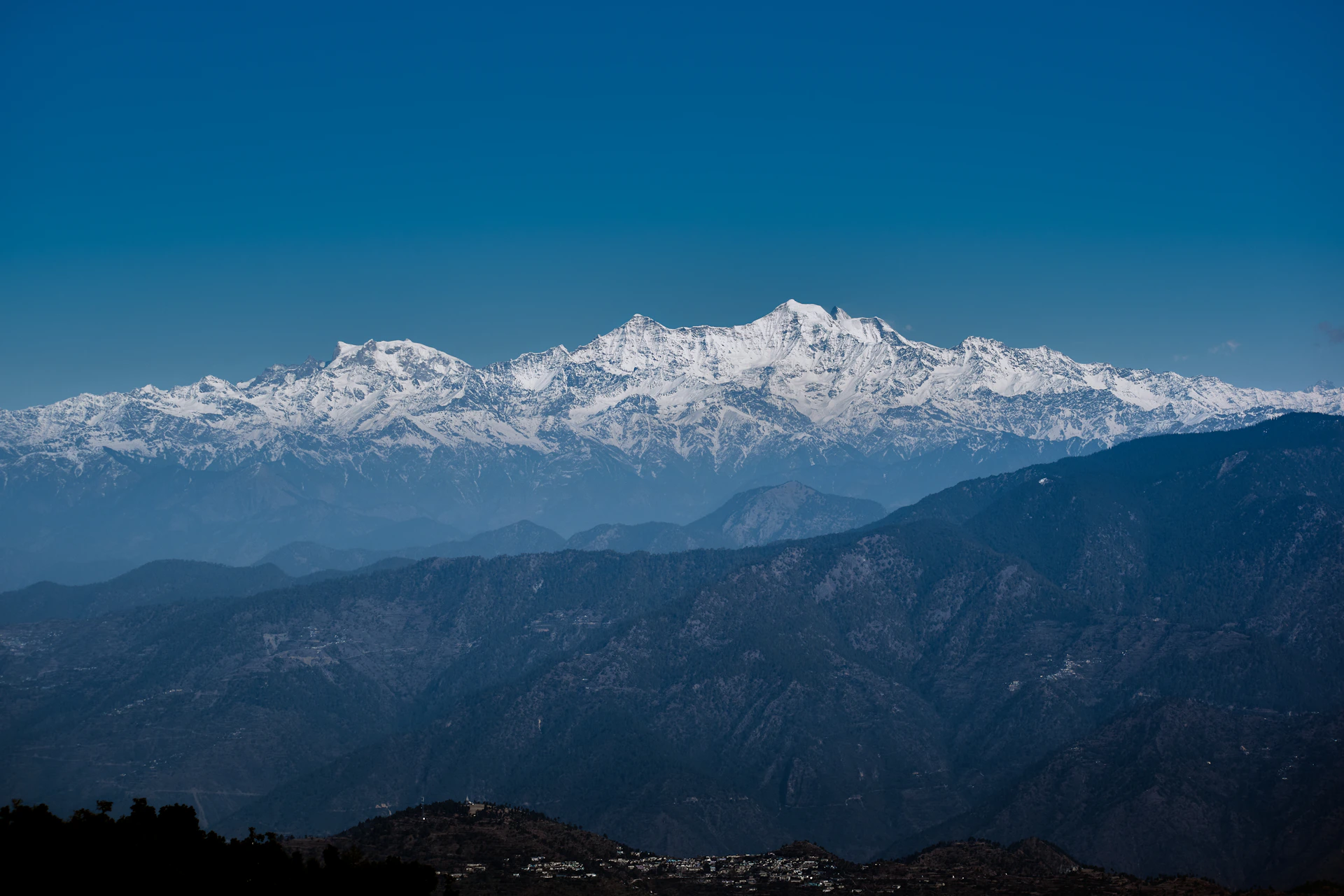 a mountain range with snow capped mountains in the background