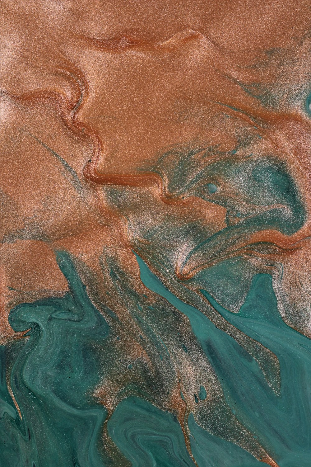 a close up of a water surface with brown and blue colors