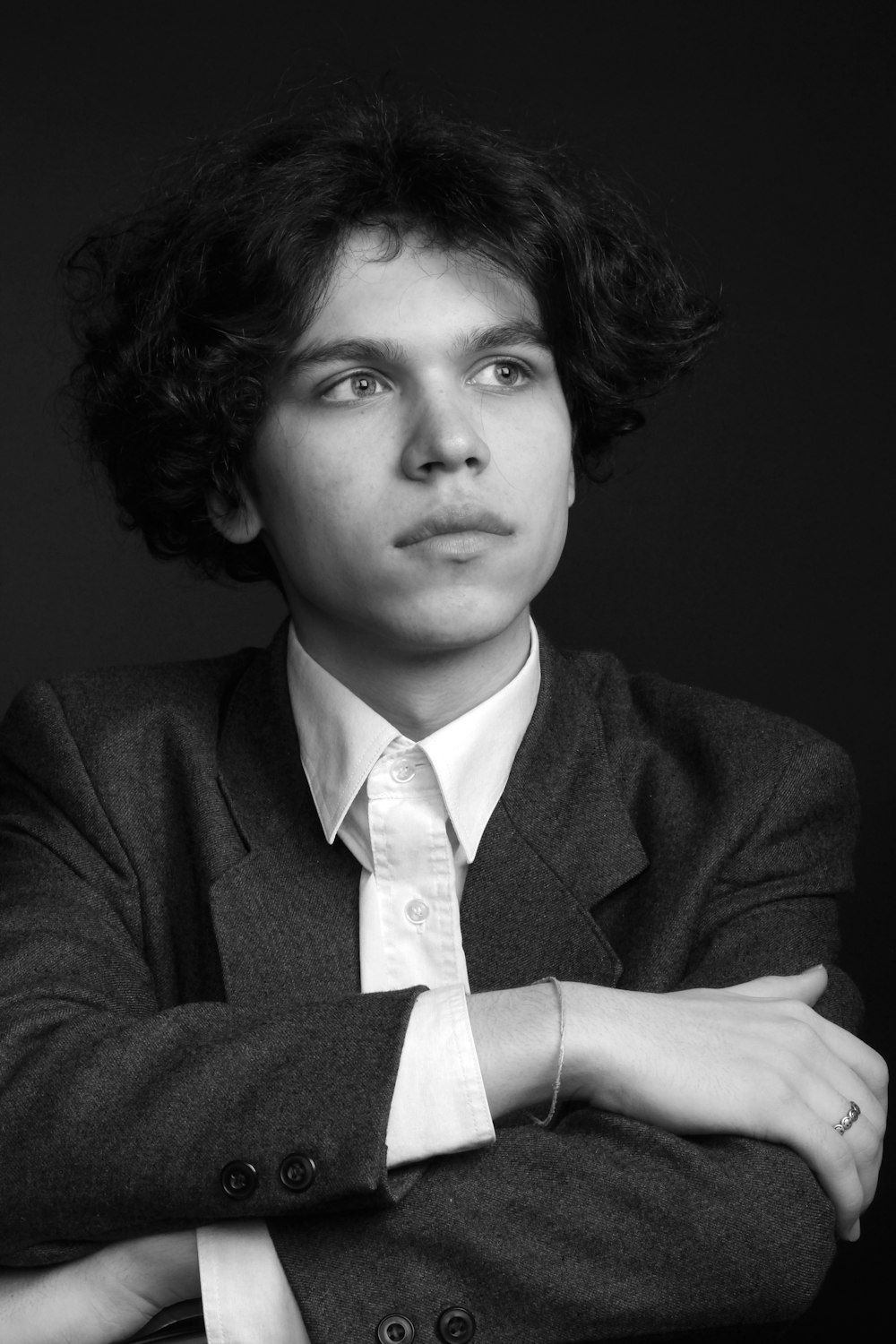 a black and white photo of a man with his arms crossed