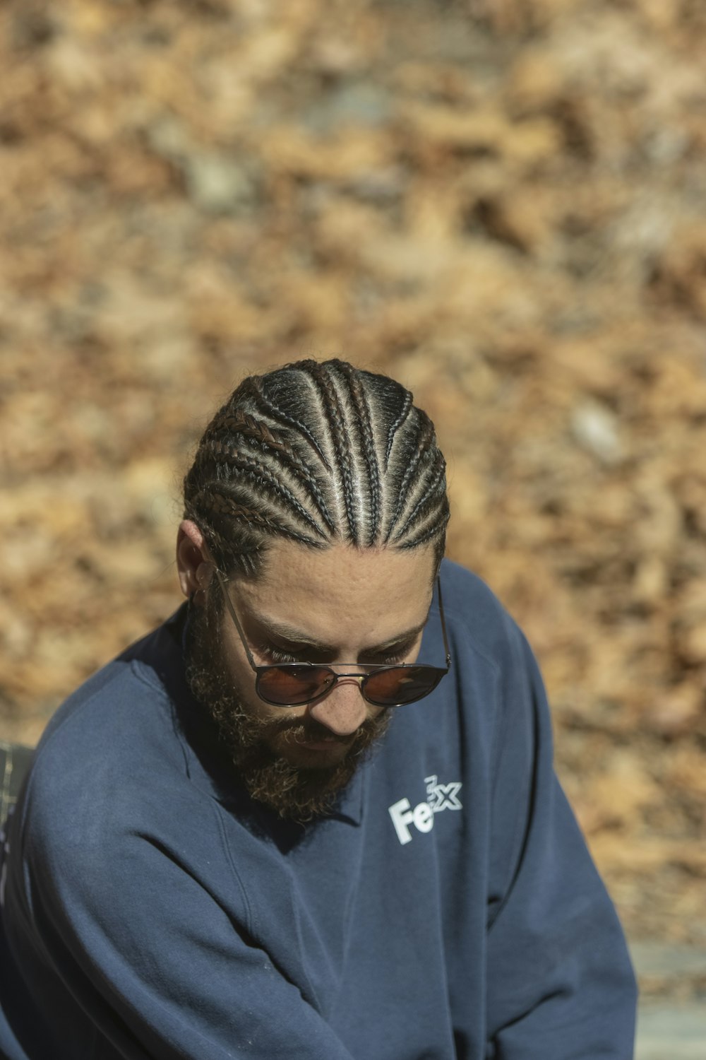 a man with long hair and a beard wearing sunglasses