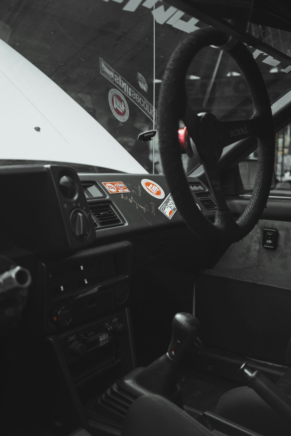 a black and white photo of a steering wheel and dashboard