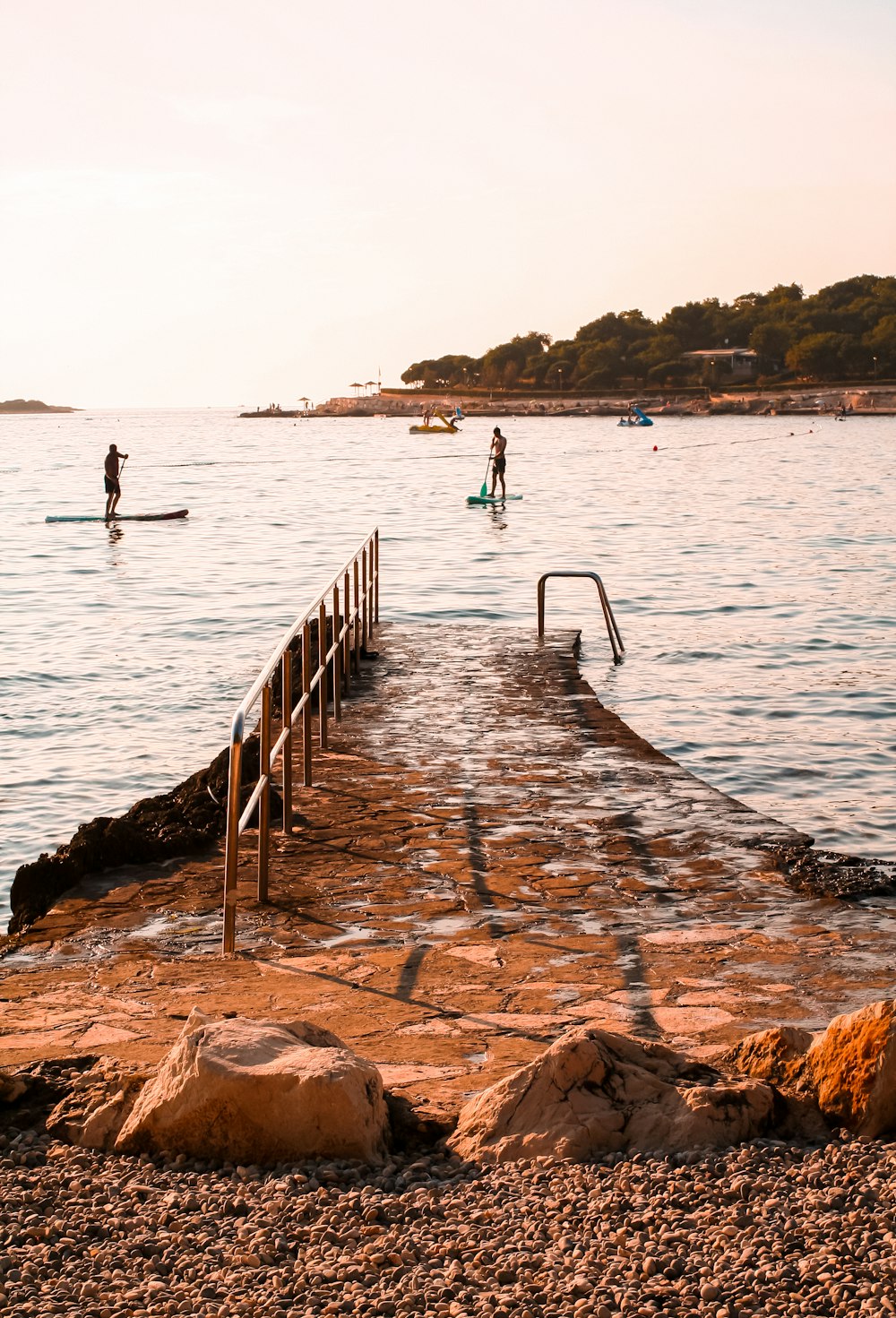 a couple of people on surfboards in the water