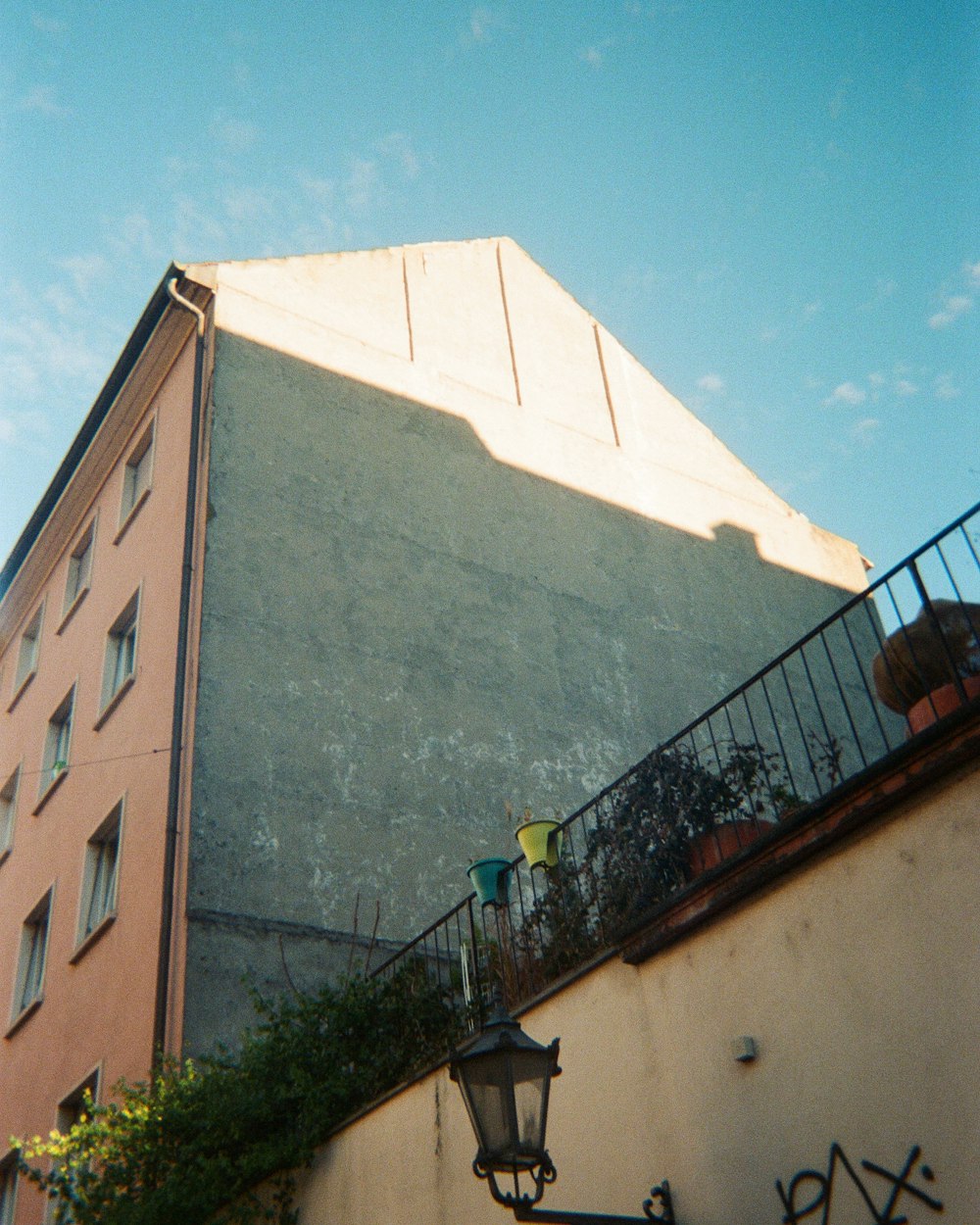 a building with a balcony next to a lamp post