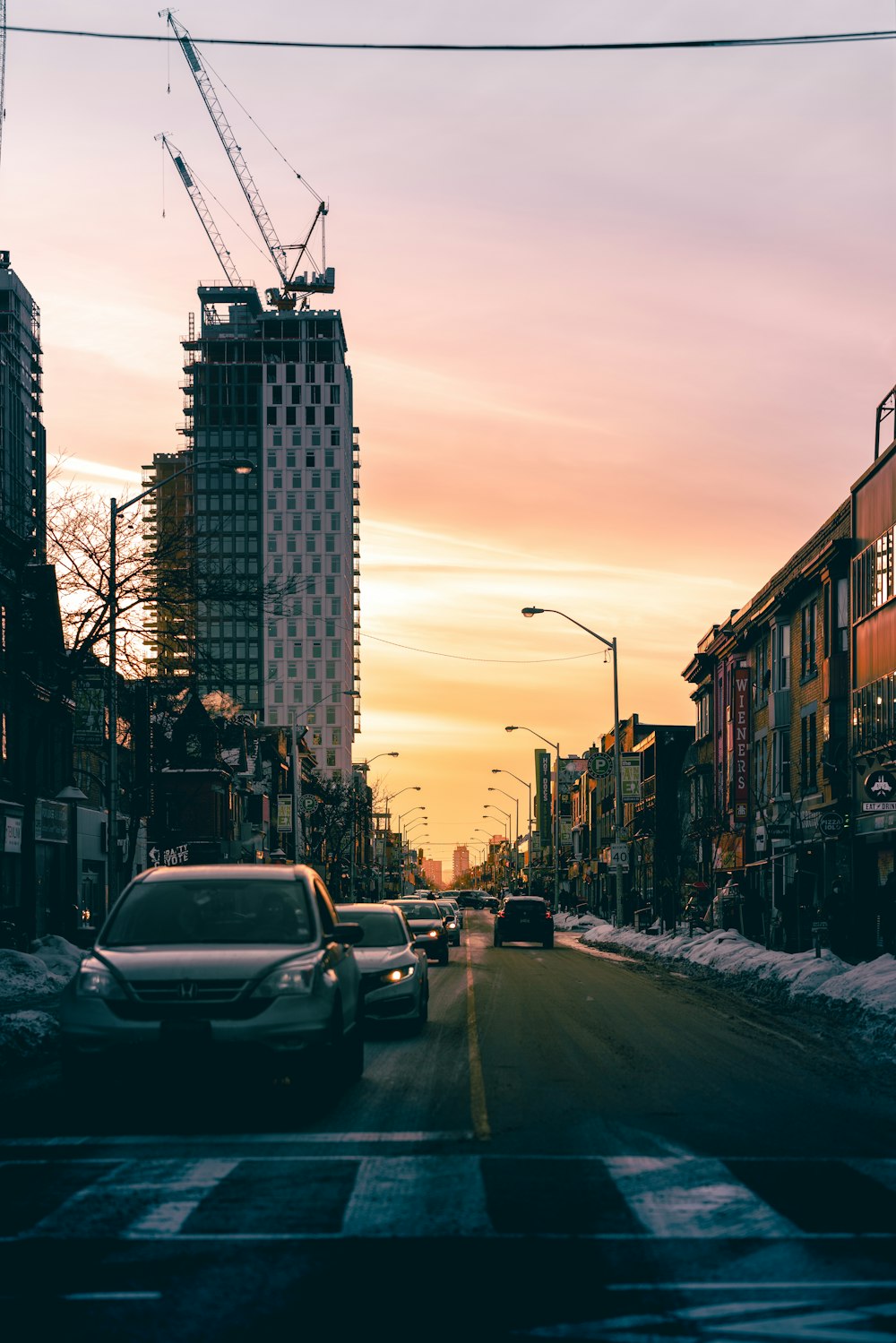 a city street filled with traffic next to tall buildings