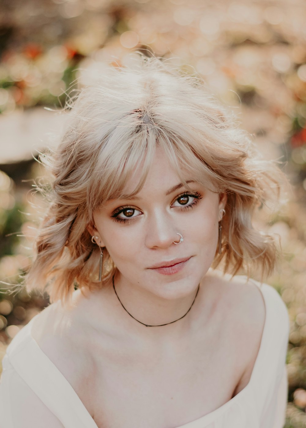 a woman with blonde hair wearing a necklace