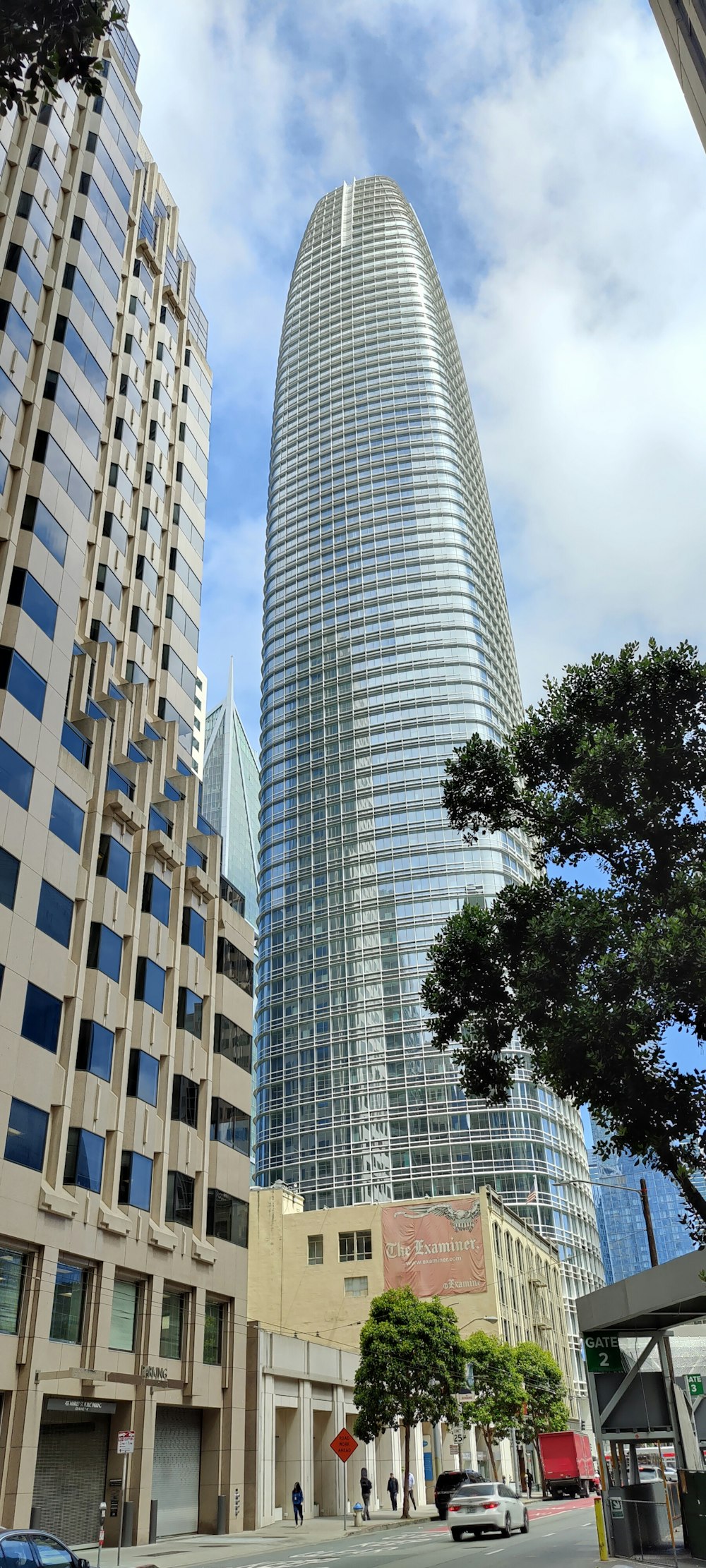 a city street with tall buildings in the background