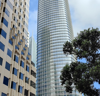 a city street with tall buildings in the background