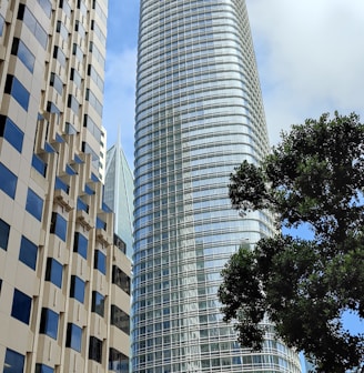 a city street with tall buildings in the background