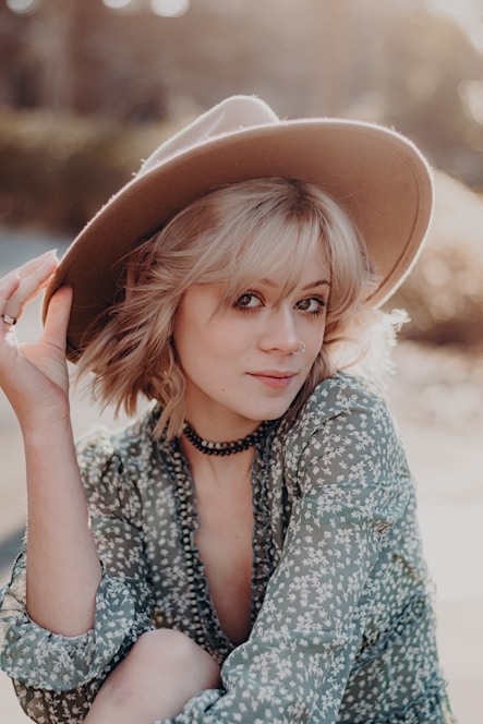a woman in a hat poses for a picture