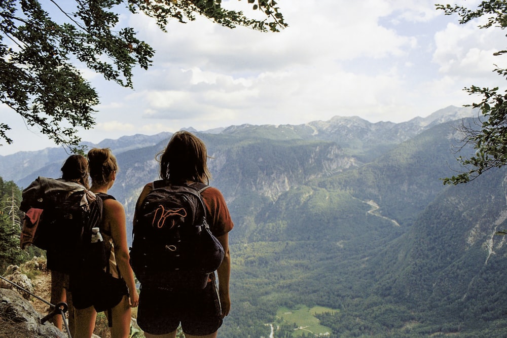 a couple of people standing on top of a mountain