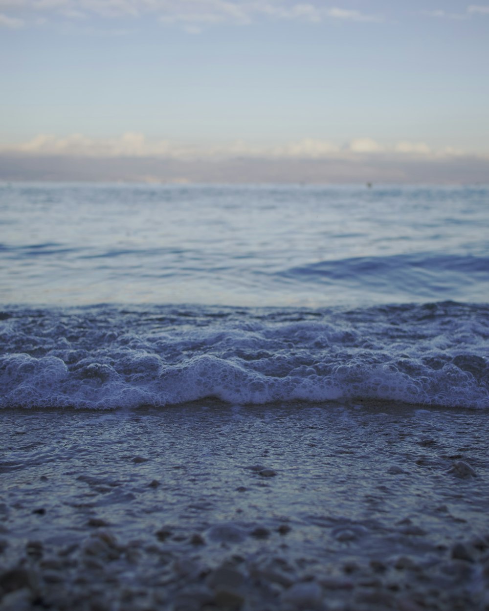 a beach with waves coming in and out of the water