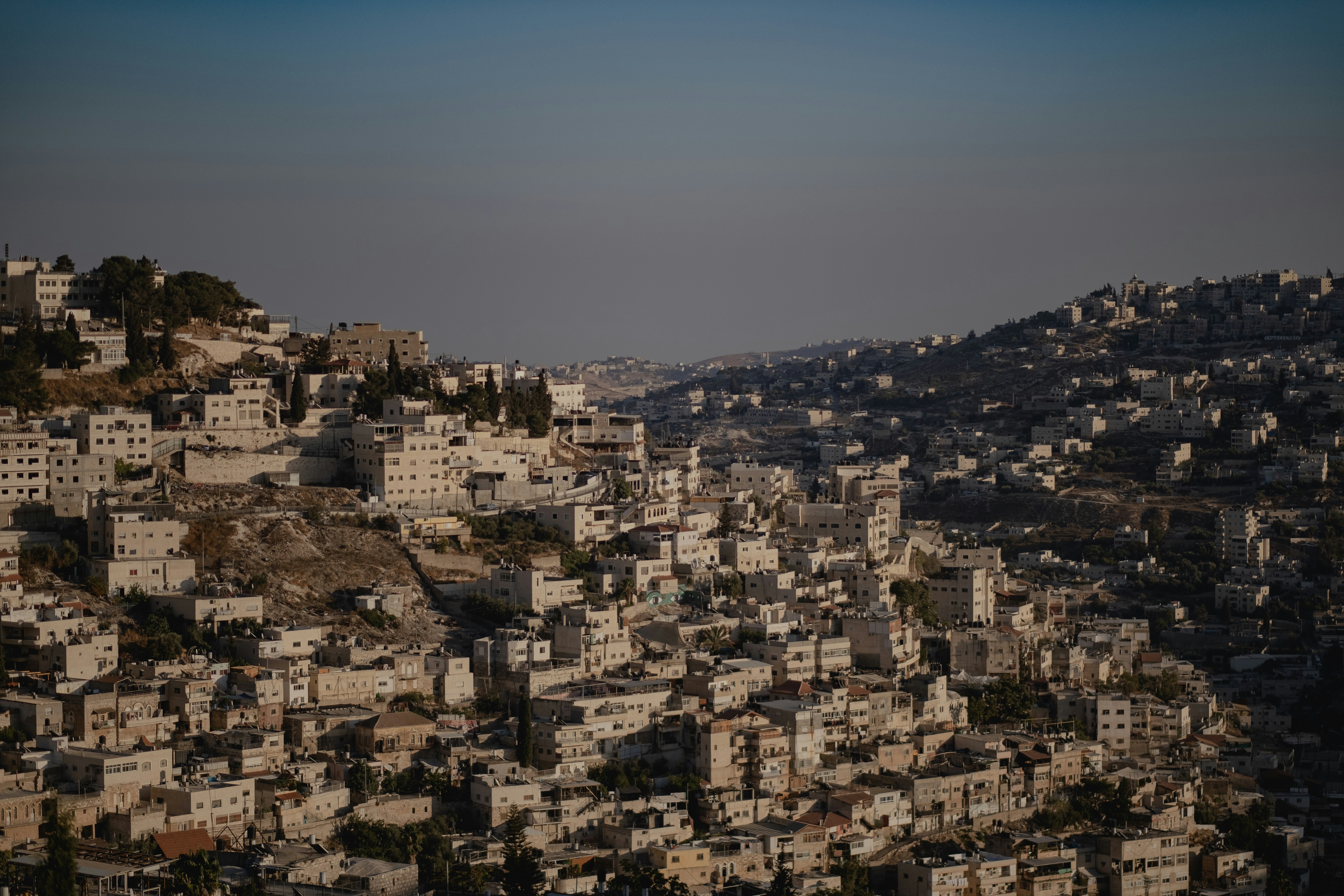 a large stone building with a mountain in the background