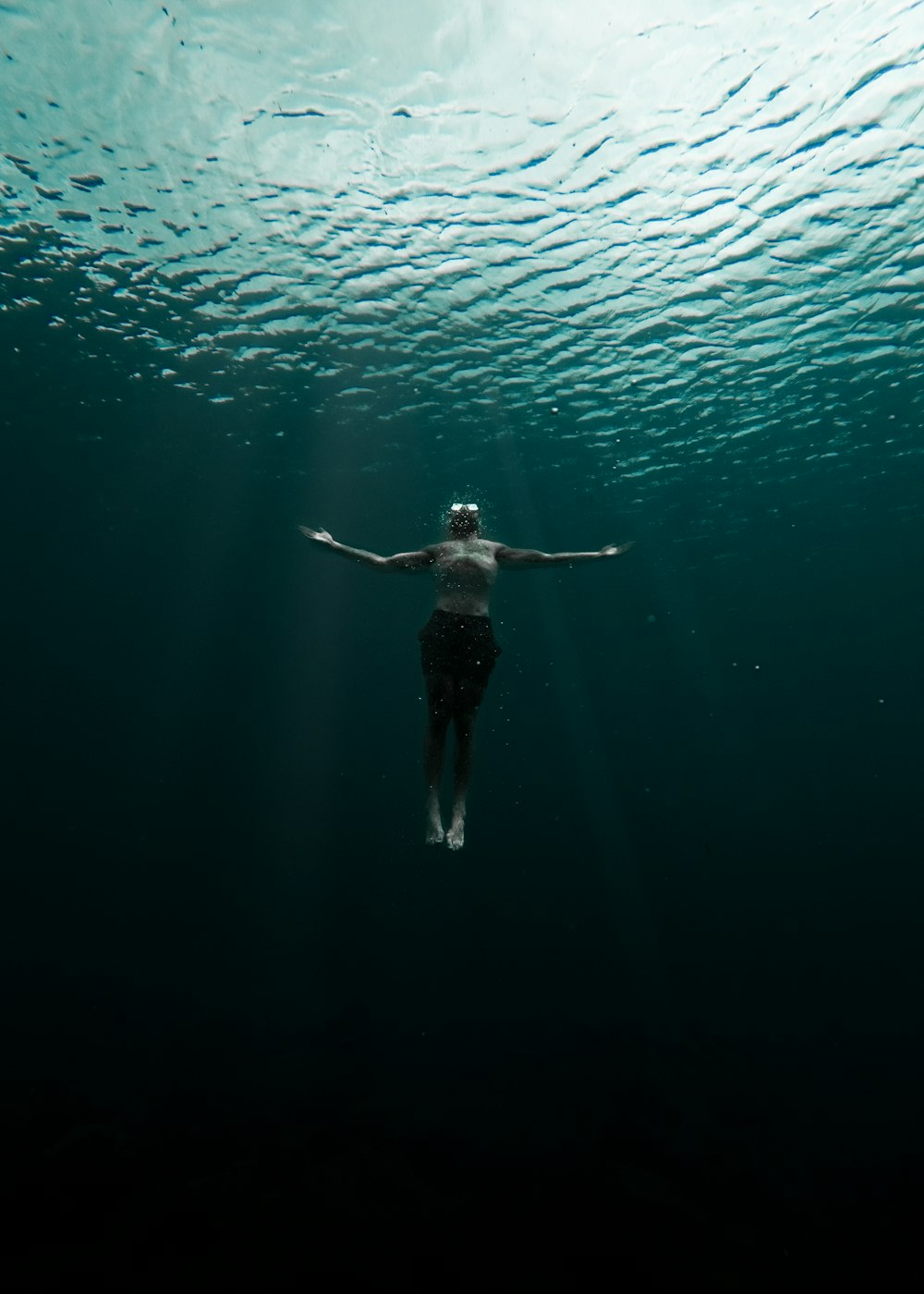 a person floating in the water with their arms outstretched