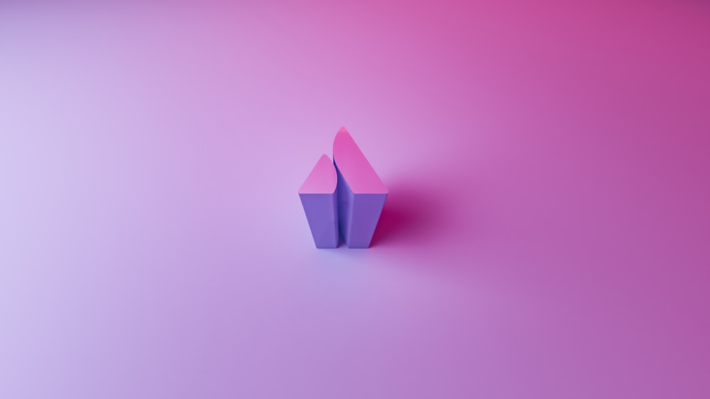 an origami object on a pink and purple background