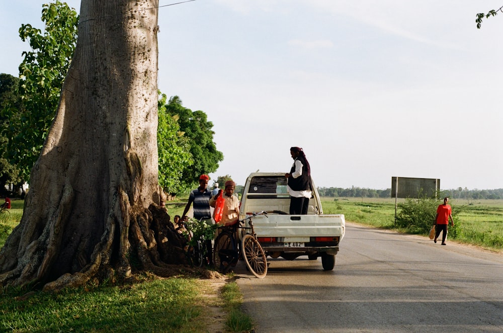 a group of people standing on the back of a truck