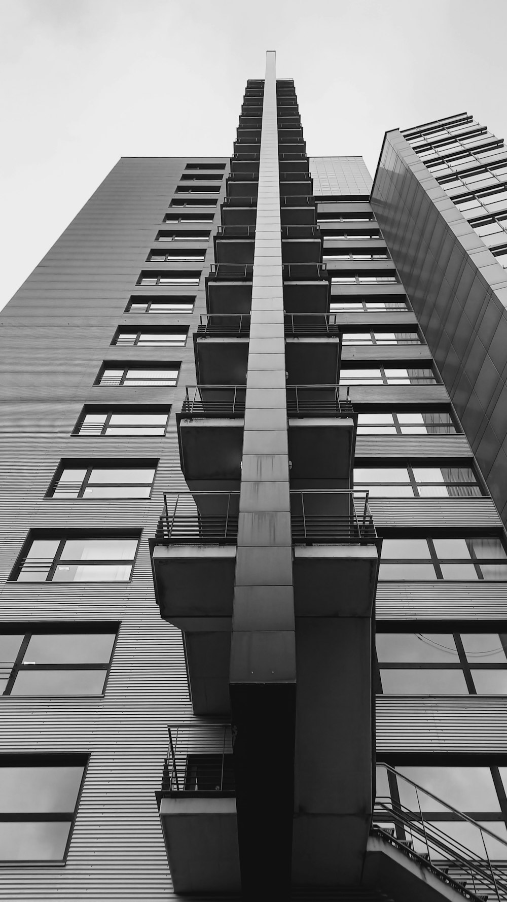 a tall building with lots of windows and balconies