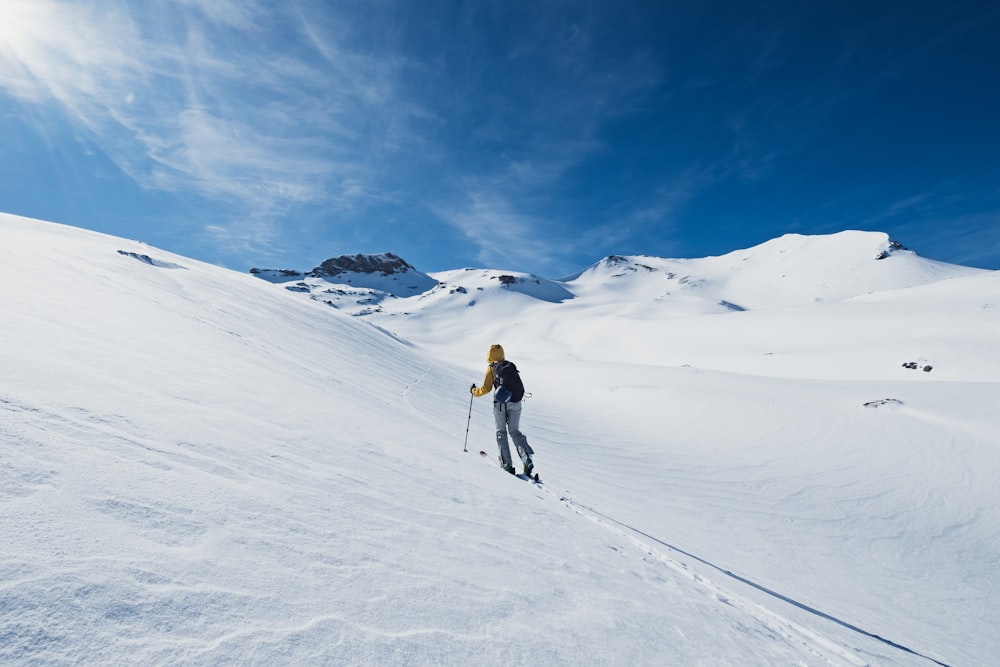 a person on skis going down a snowy hill