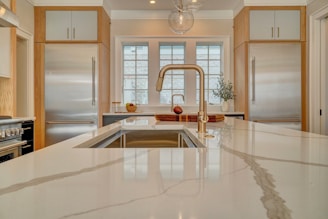 a kitchen with a sink, stove, and refrigerator