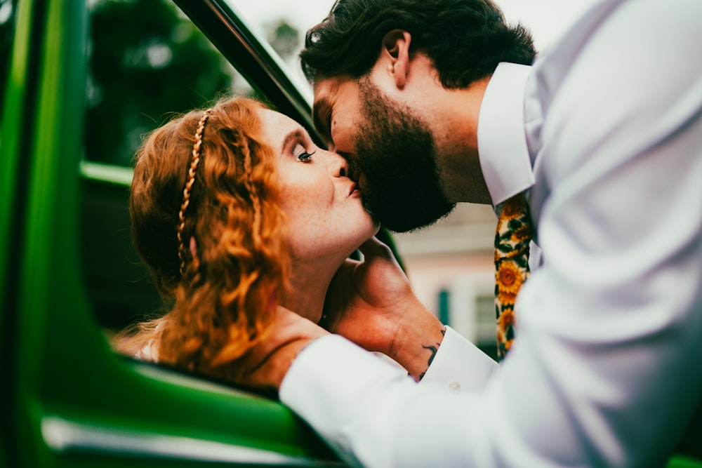 a man and a woman kissing in a car