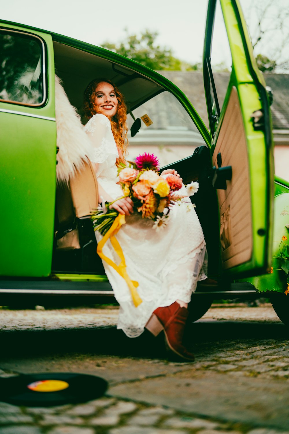 a woman sitting in the back of a green truck