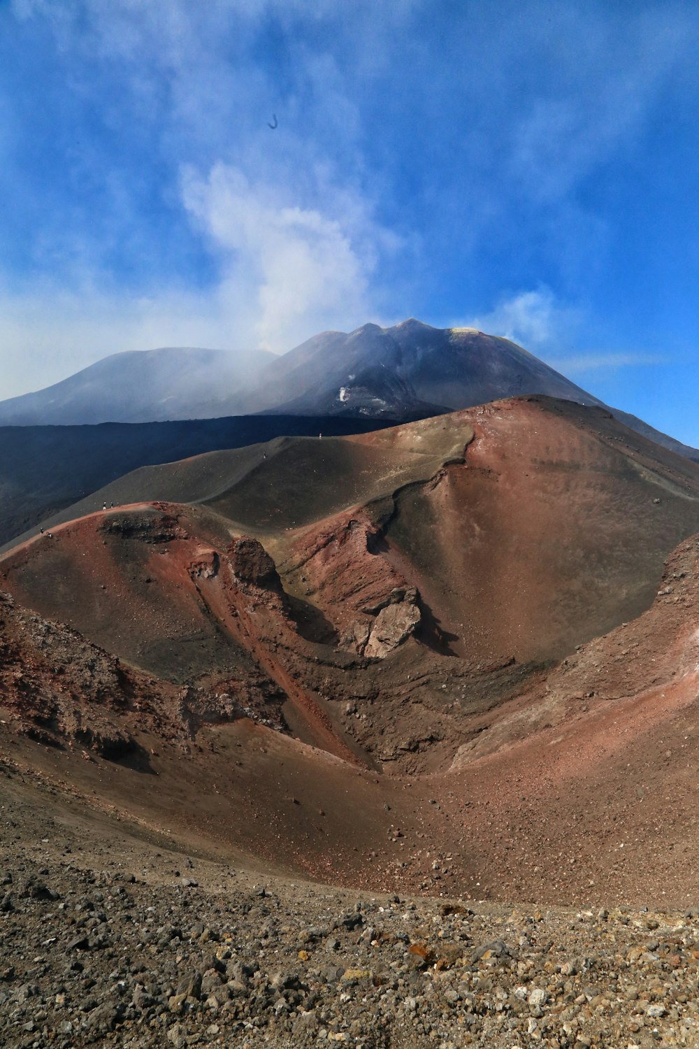 a view of a mountain with a cloud in the sky