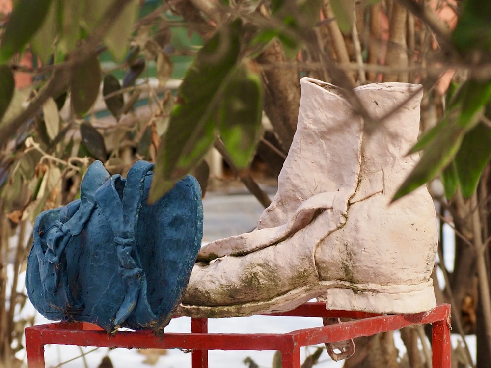 a pair of shoes sitting on top of a red bench