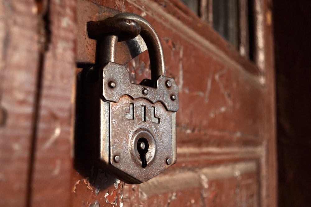 an old padlock on a wooden door