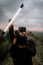 a man holding a camera and a video camera
