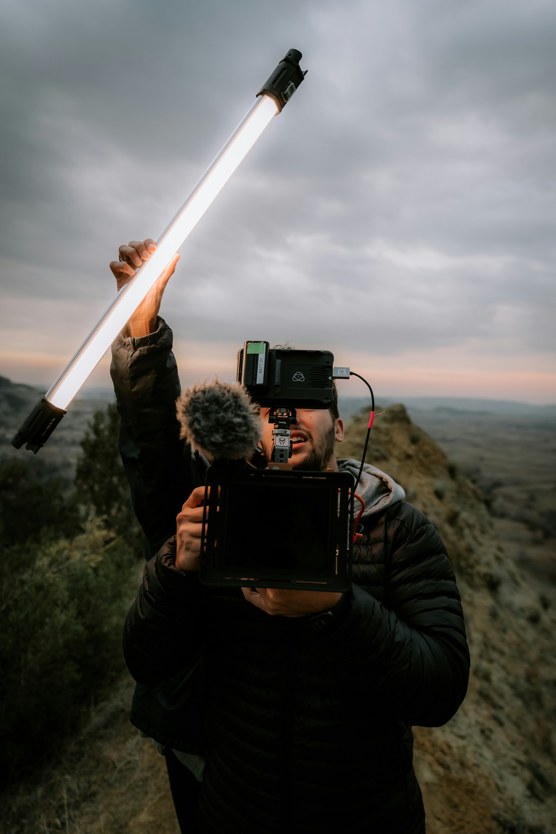 a man holding a camera and a video camera