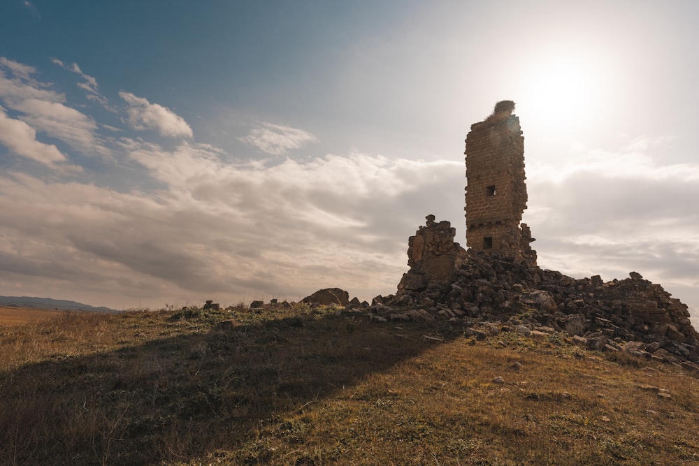 a very tall tower sitting on top of a hill