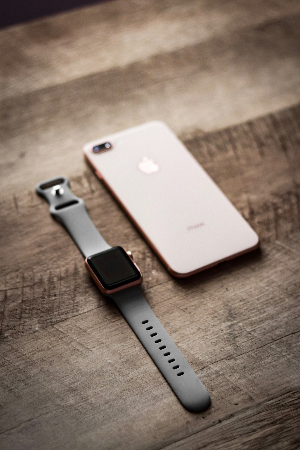 an apple watch sitting next to an iphone