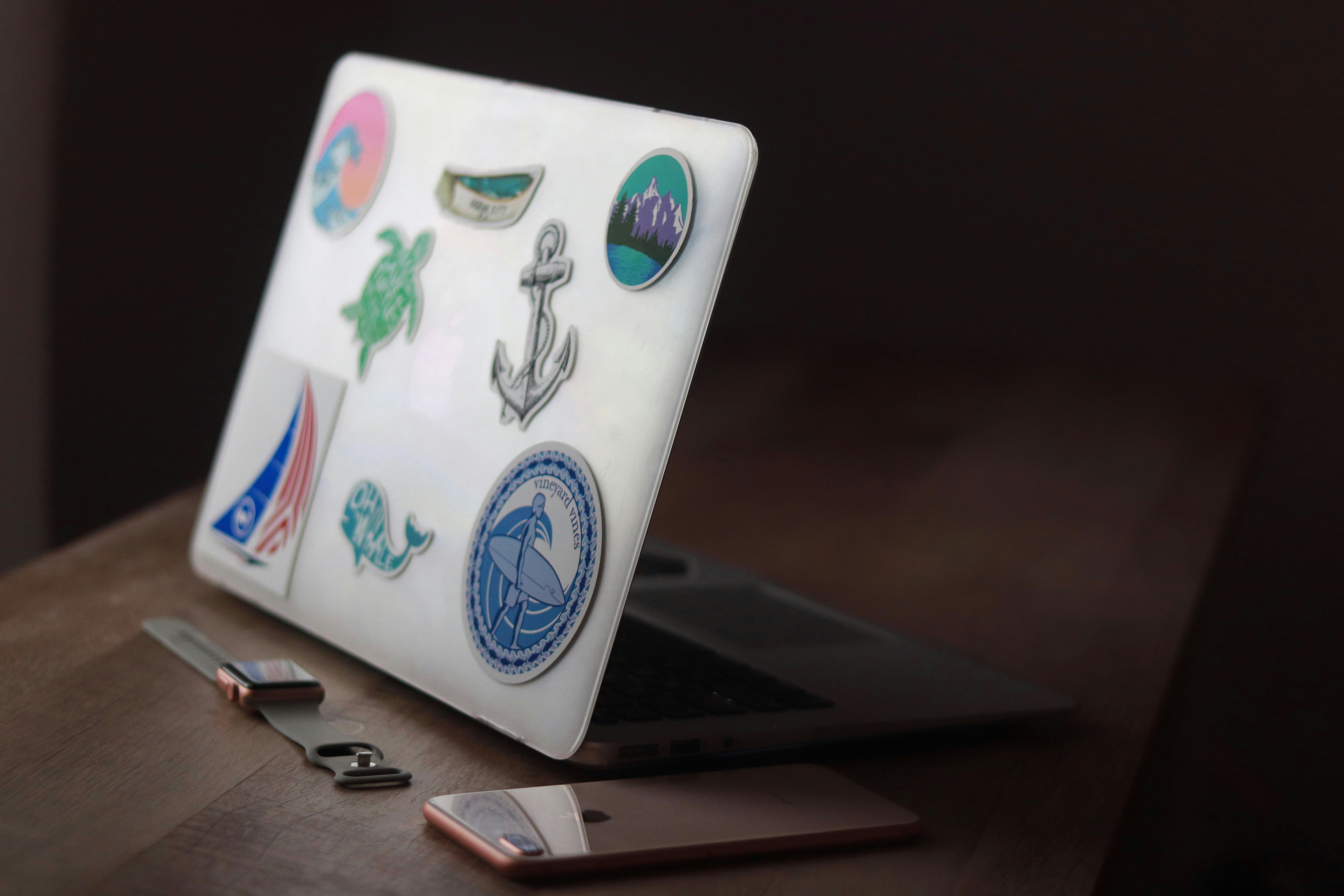 a laptop computer sitting on top of a wooden desk