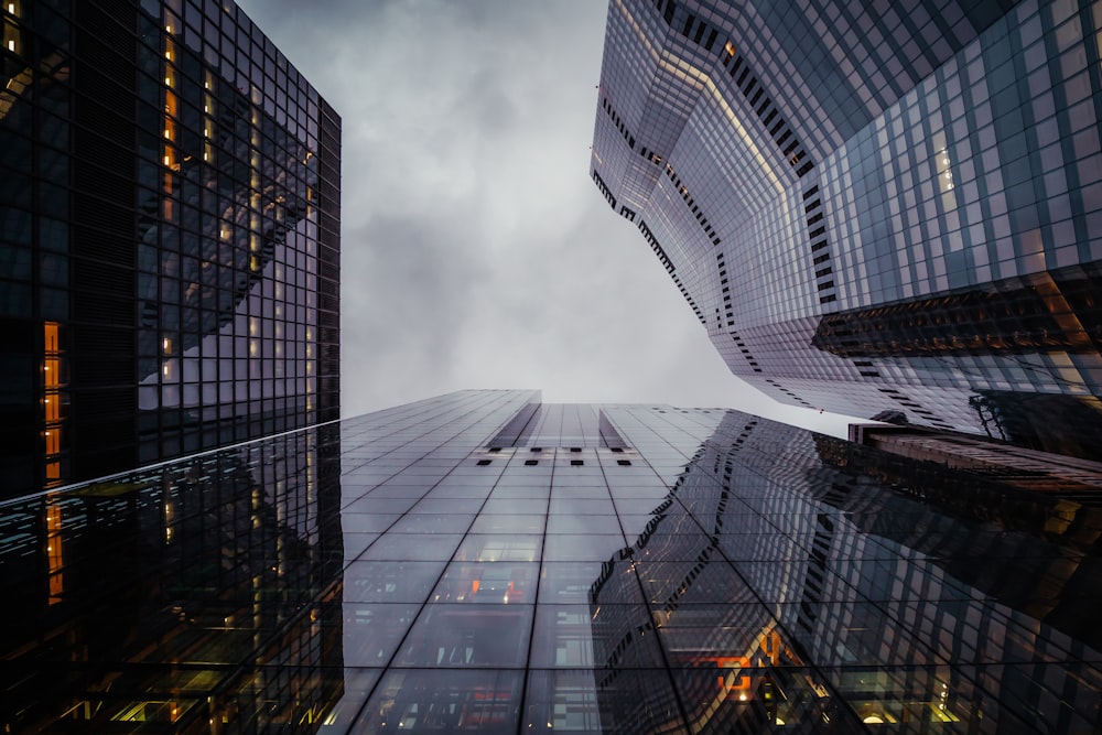 a group of tall buildings with a cloudy sky in the background