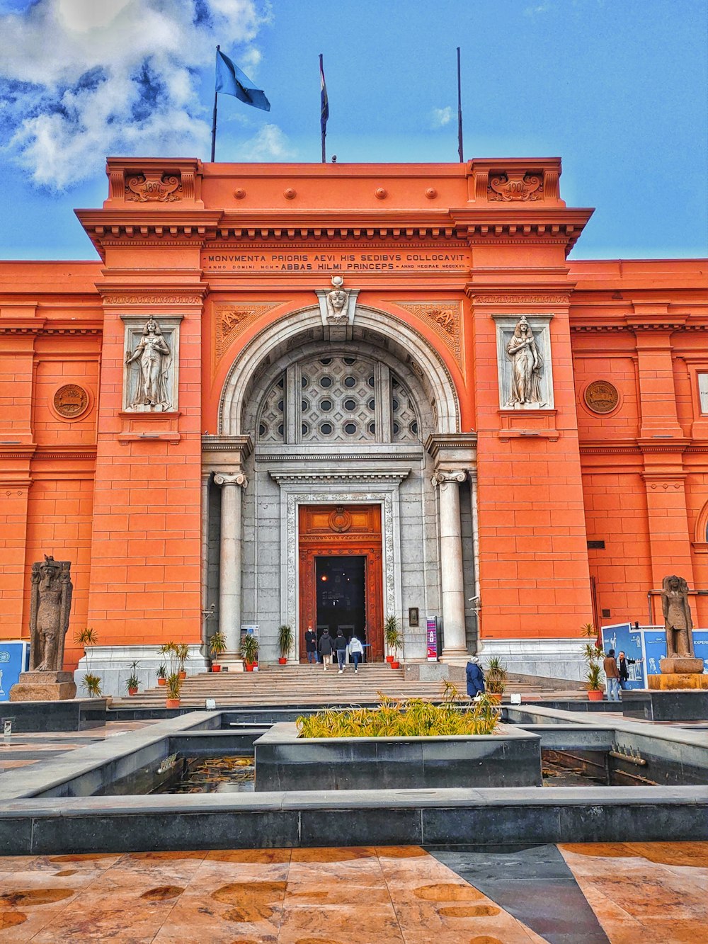 a large orange building with a clock on the front of it