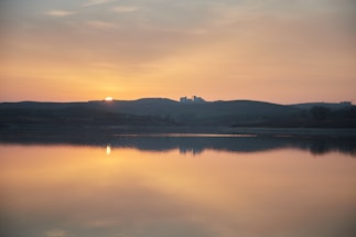 A calming scene of a serene landscape with a sunset.