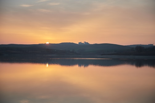 A calming scene of a serene landscape with a sunset.