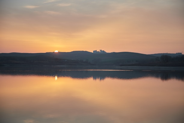 A serene landscape showcasing a beautiful sunset over a tranquil beach.