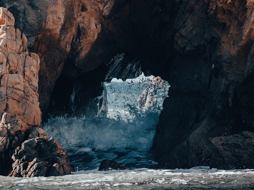 a cave with a large amount of water coming out of it