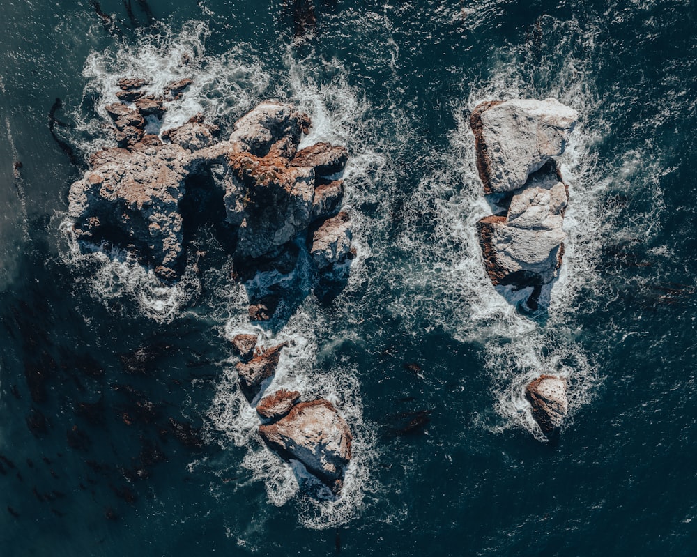 a group of rocks in the middle of the ocean
