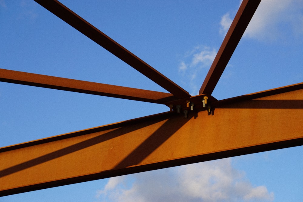 a close up of a metal structure with a sky background