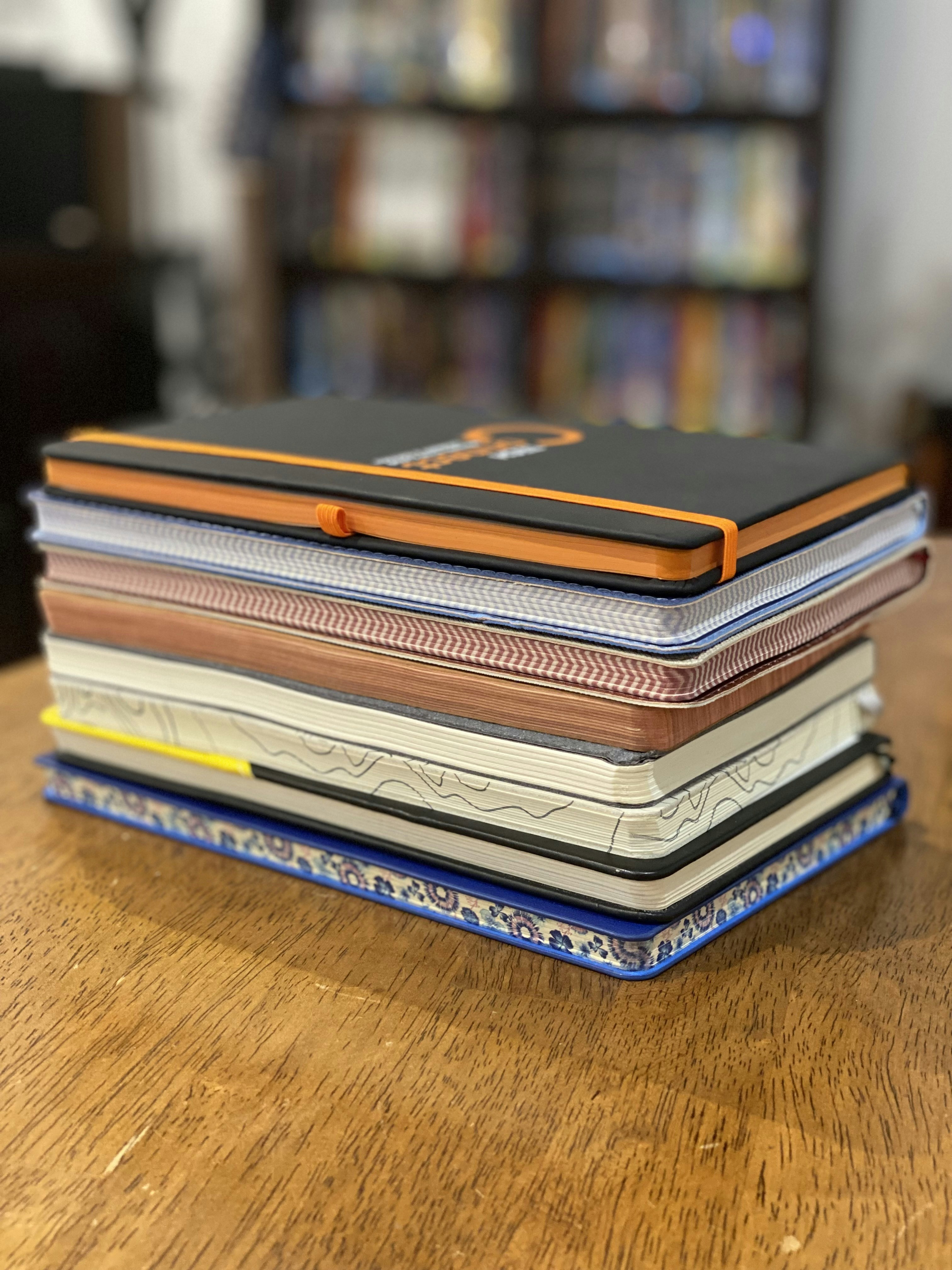 Stack of school notebooks with colorful covers, stationery shop display
