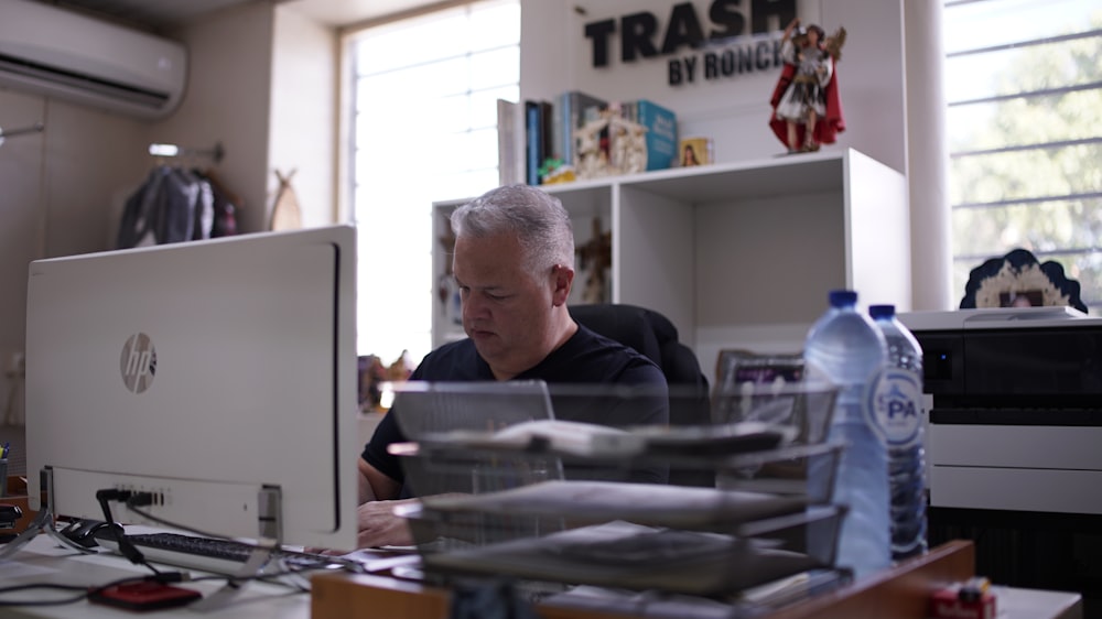 a man sitting at a desk in front of a computer