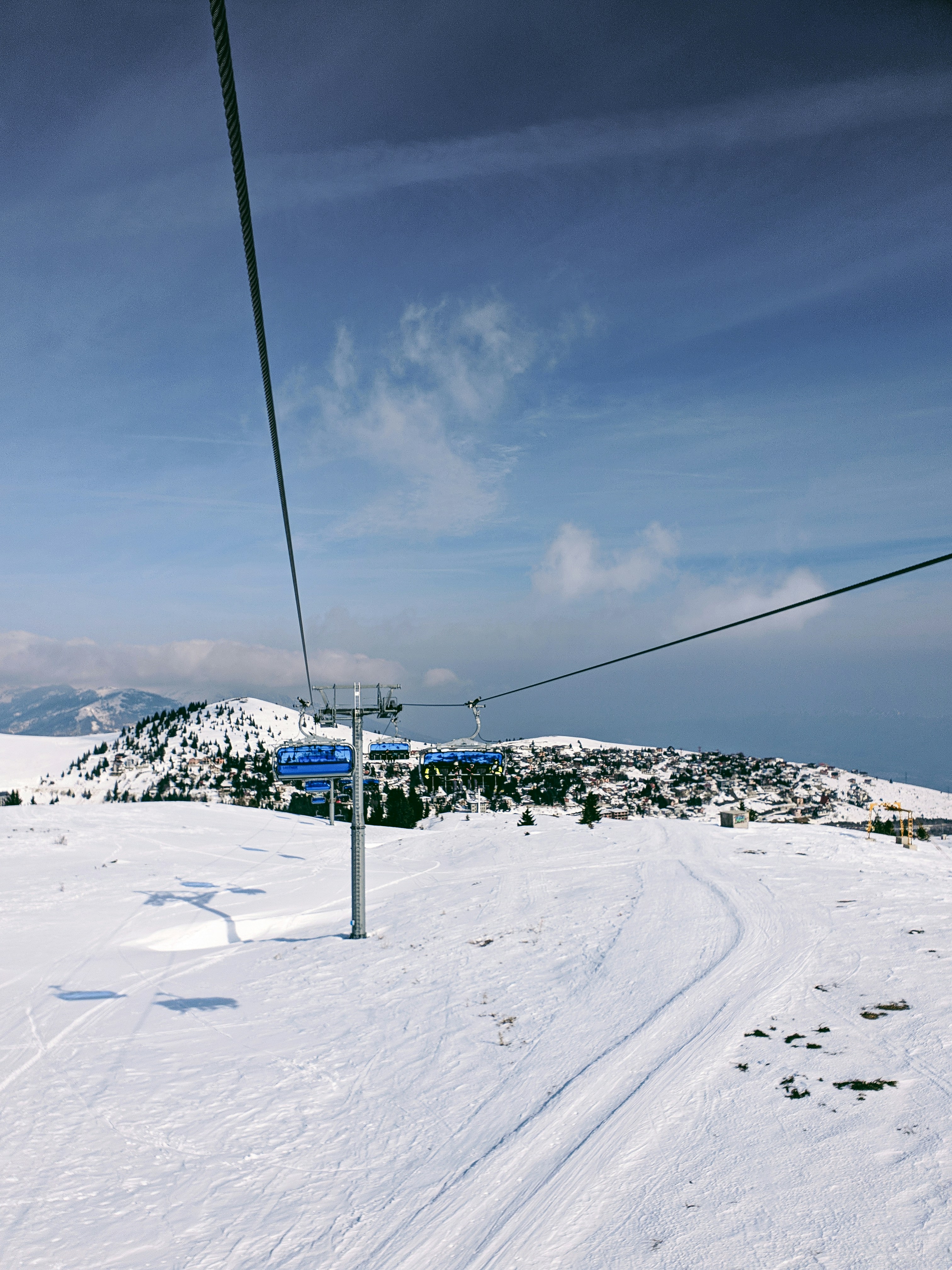 a ski lift going up a snowy hill
