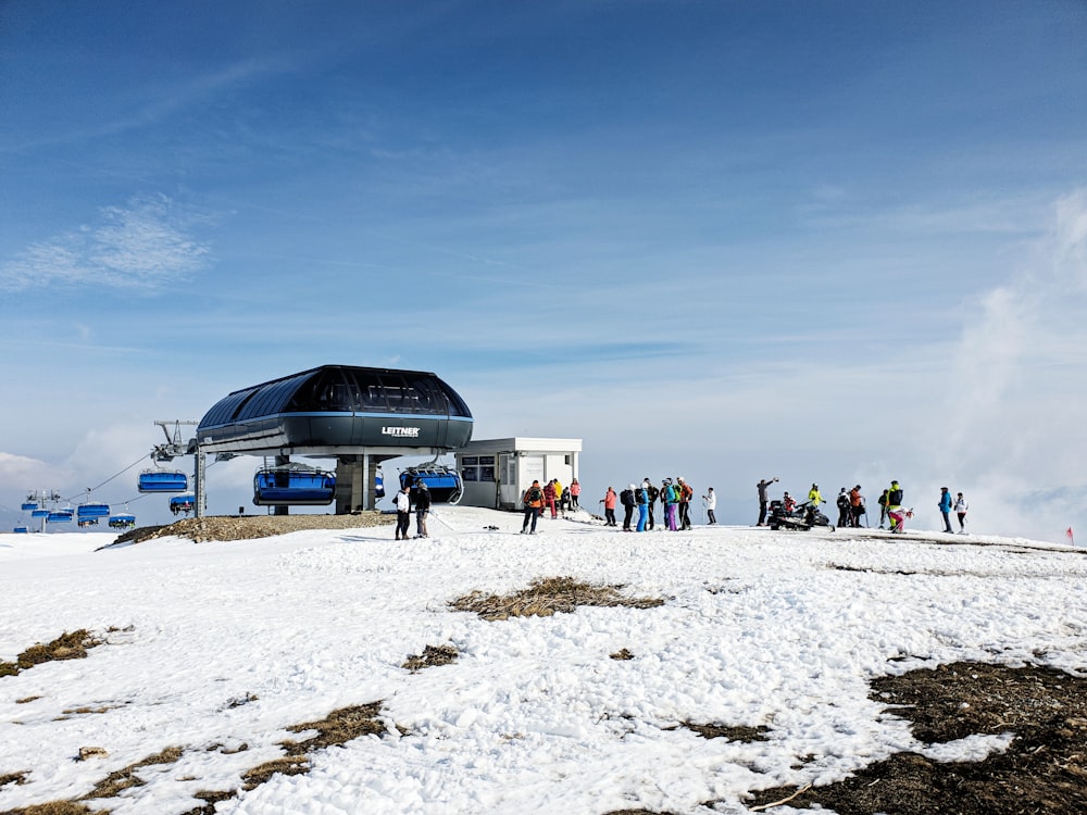 a group of people standing on top of a snow covered slope