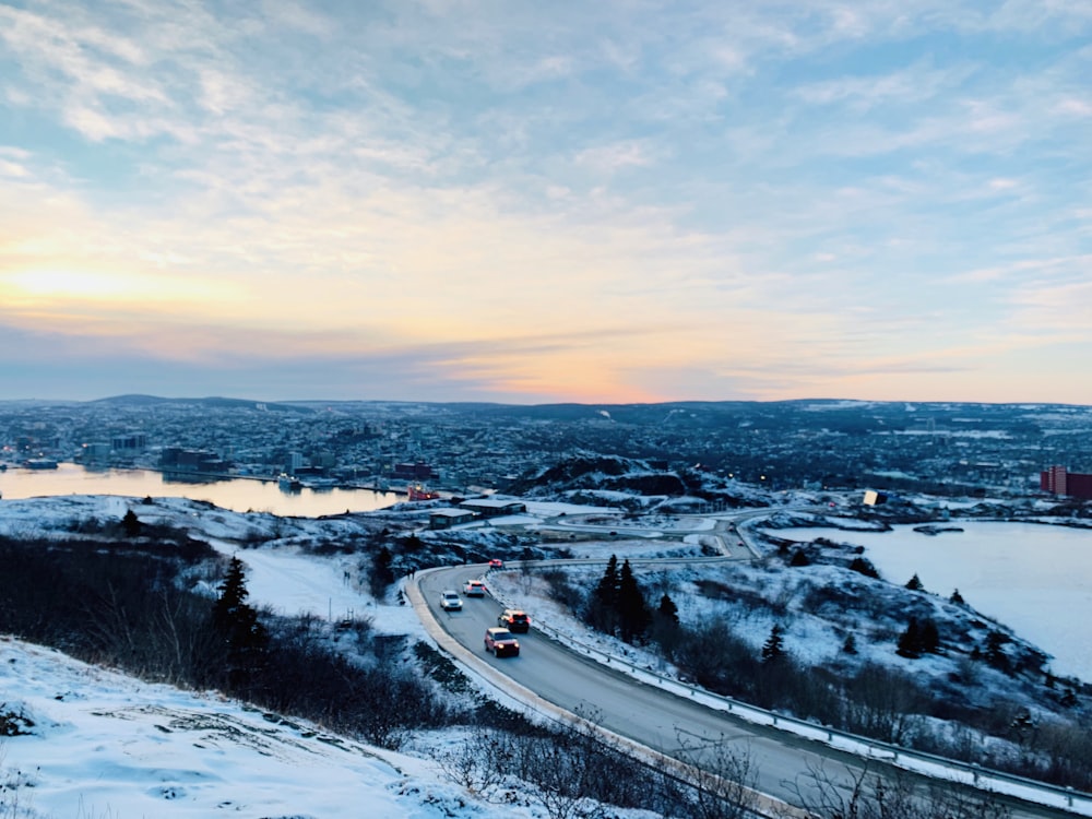 a view of a snowy road and a body of water