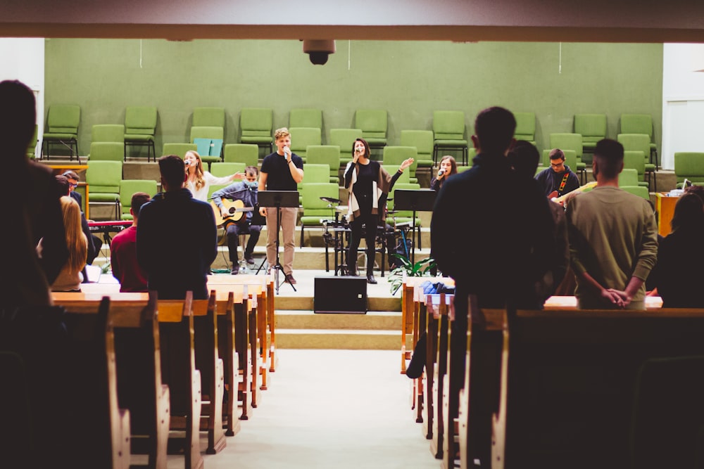 a group of people standing in front of a stage