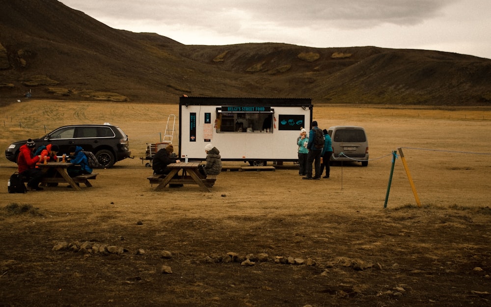 a group of people sitting at a picnic table