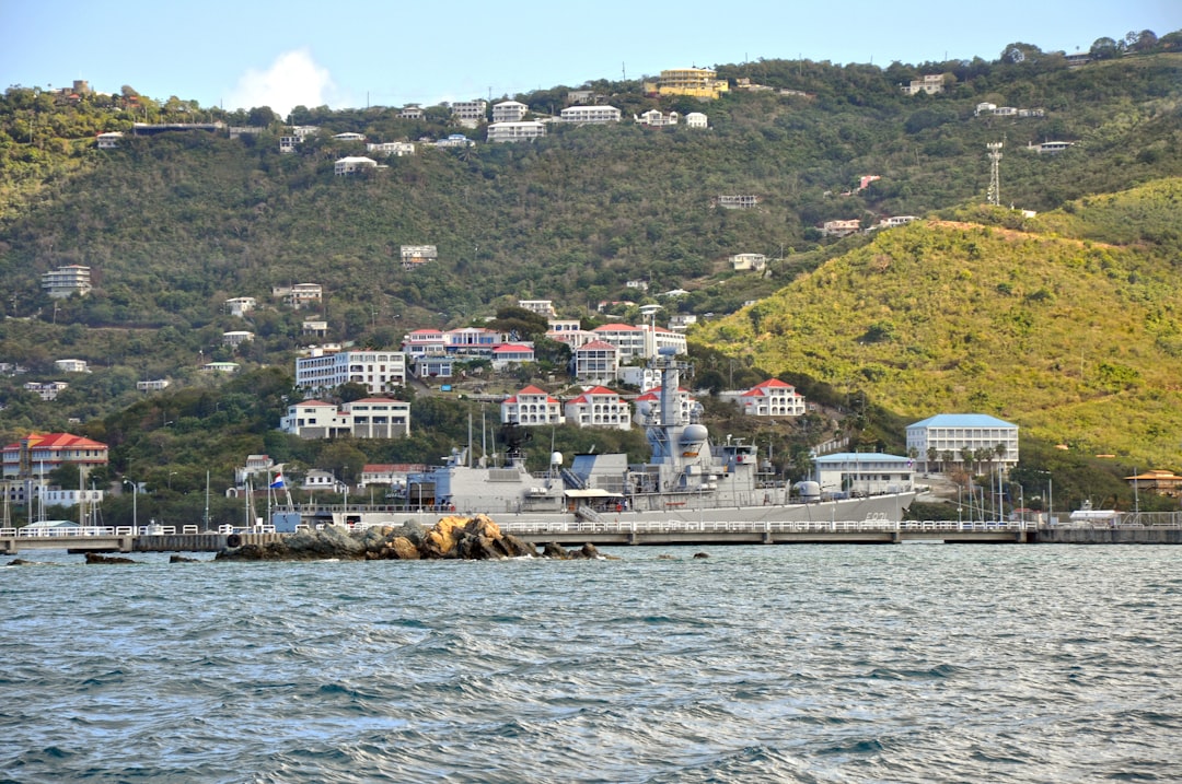 a large boat floating on top of a body of water, A Netherlands military ship docks in Charlotte Amlie Harbor at the West